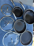 Pre-owned HexClad seven-piece hybrid cookware set with pans, lids and wok