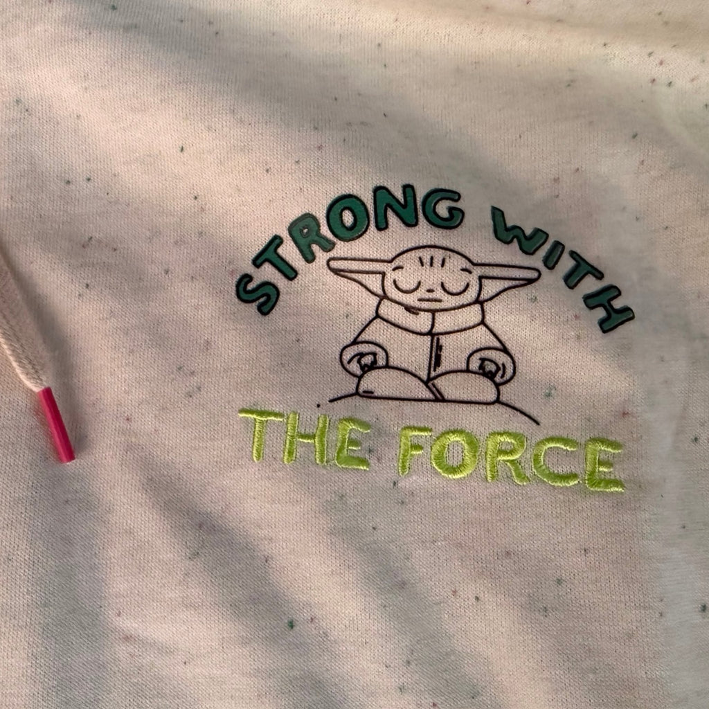 Grogu Strong With The Force chest graphic on cream speckled fabric