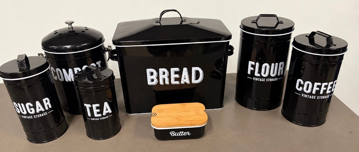 Seven-piece black farmhouse kitchen storage set: bread, flour, coffee, sugar, compost, tea and butter — bacon grease canister excluded