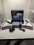 Mini Game Anniversary Edition console with two controllers, USB power adapter, and AV cable set up
