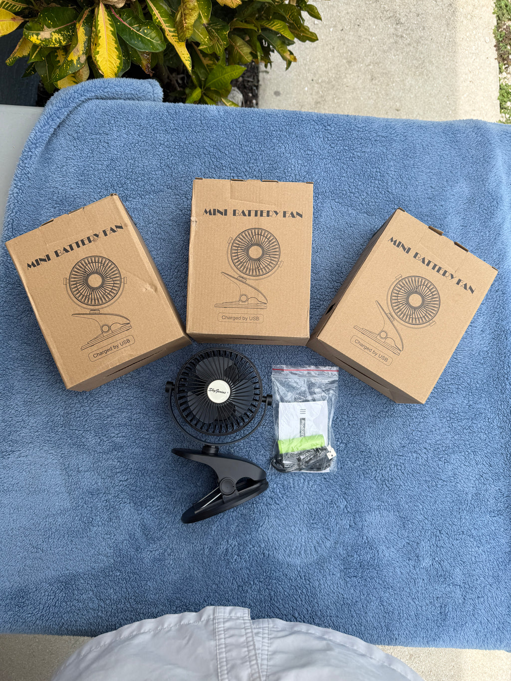 SkyGenius mini rechargeable clip fan with USB cable and battery