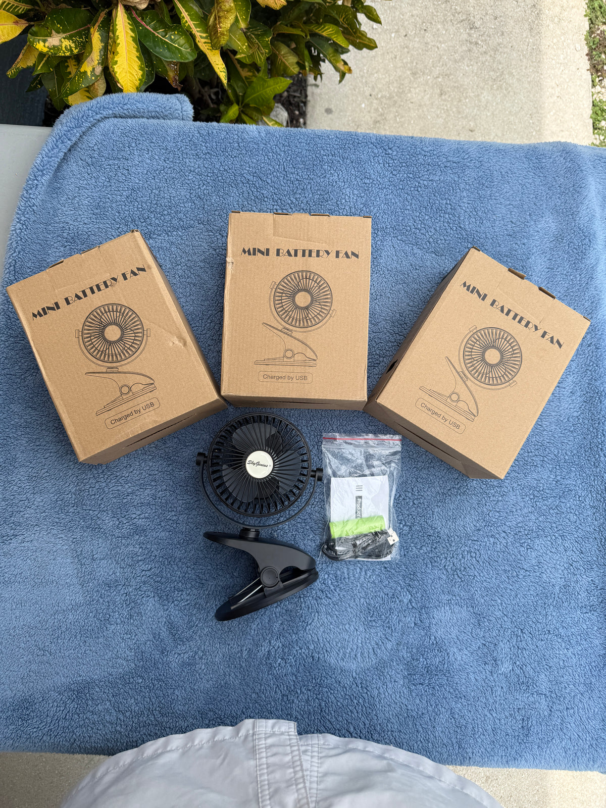 SkyGenius mini rechargeable clip fan with USB cable and battery