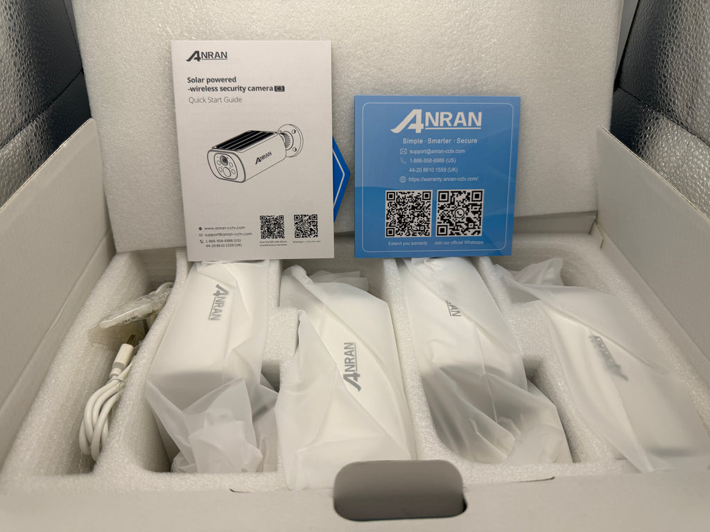 Inside packaging showing 4 cameras wrapped and documentation