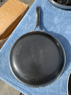 Underside of Hexclad frying pan with Hexclad logo and hexagon pattern
