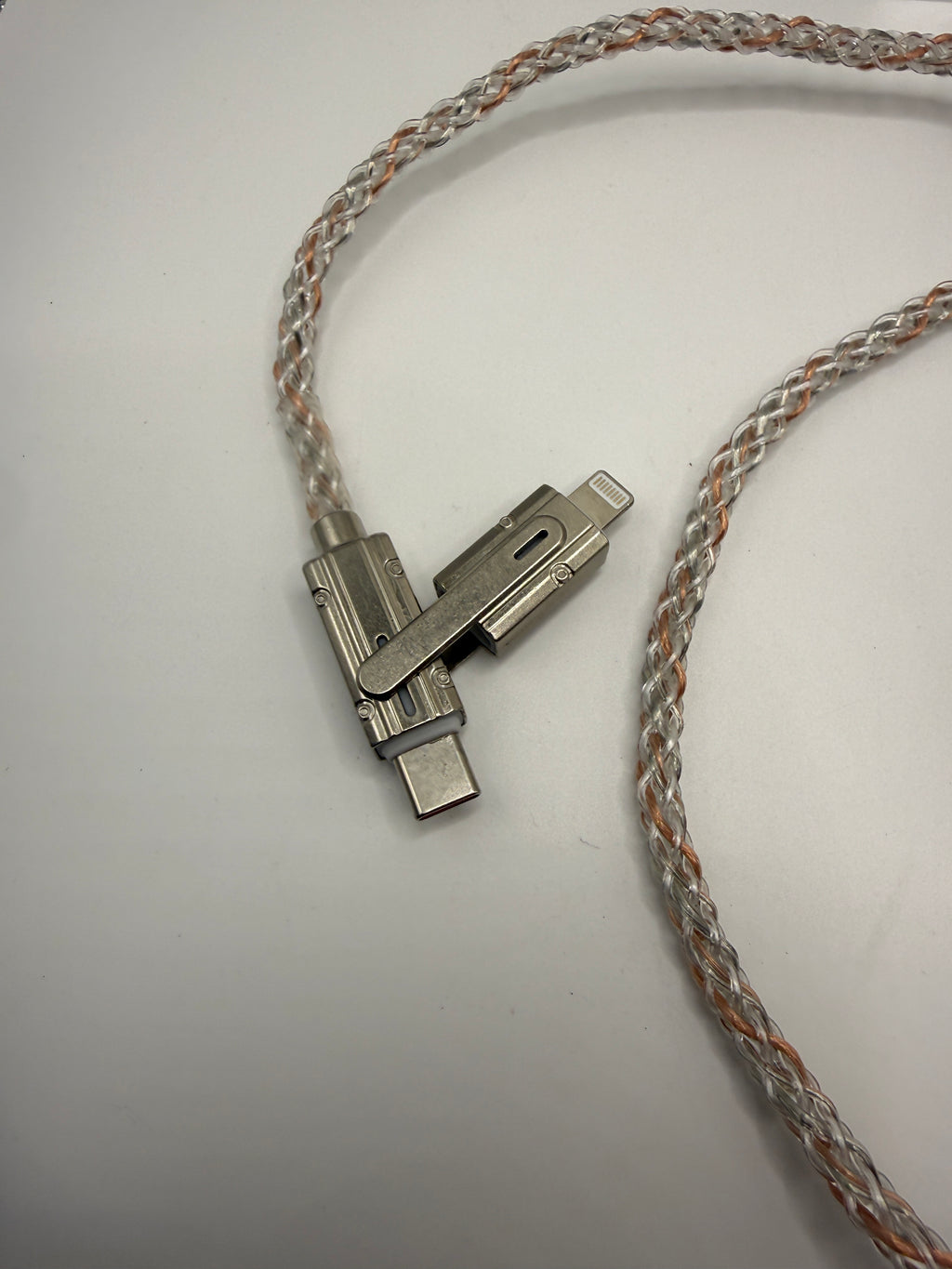 Close-up of metal swivel USB-C and Lightning connectors on braided cable
