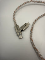 Close-up of metal swivel USB-C and Lightning connectors on braided cable