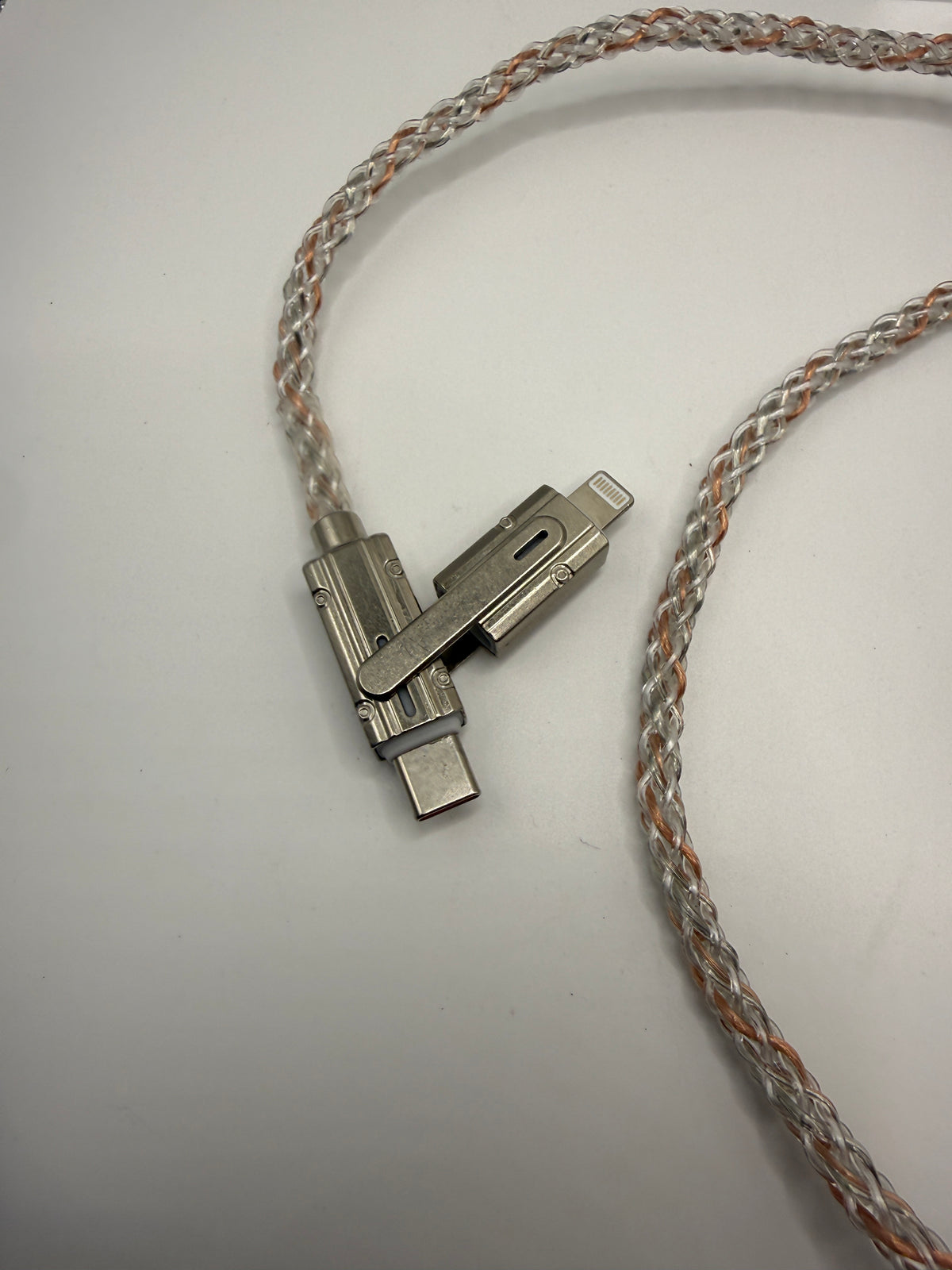 Close-up of metal swivel USB-C and Lightning connectors on braided cable