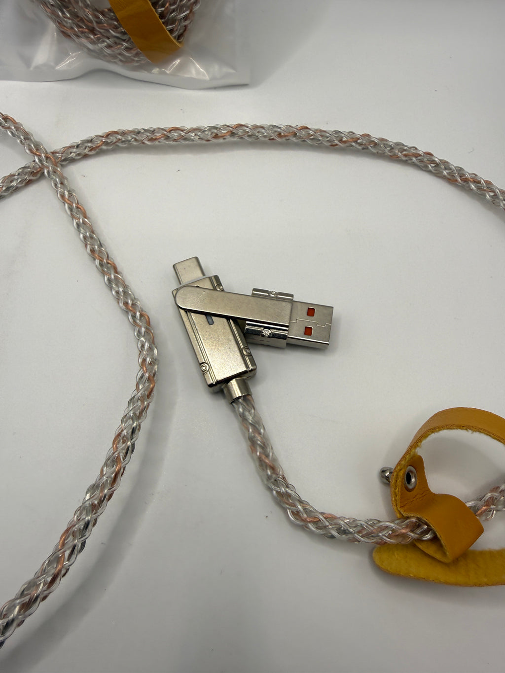 Close-up of metal swivel USB and Lightning connectors with yellow cable tie