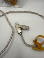 Close-up of metal swivel USB and Lightning connectors with yellow cable tie