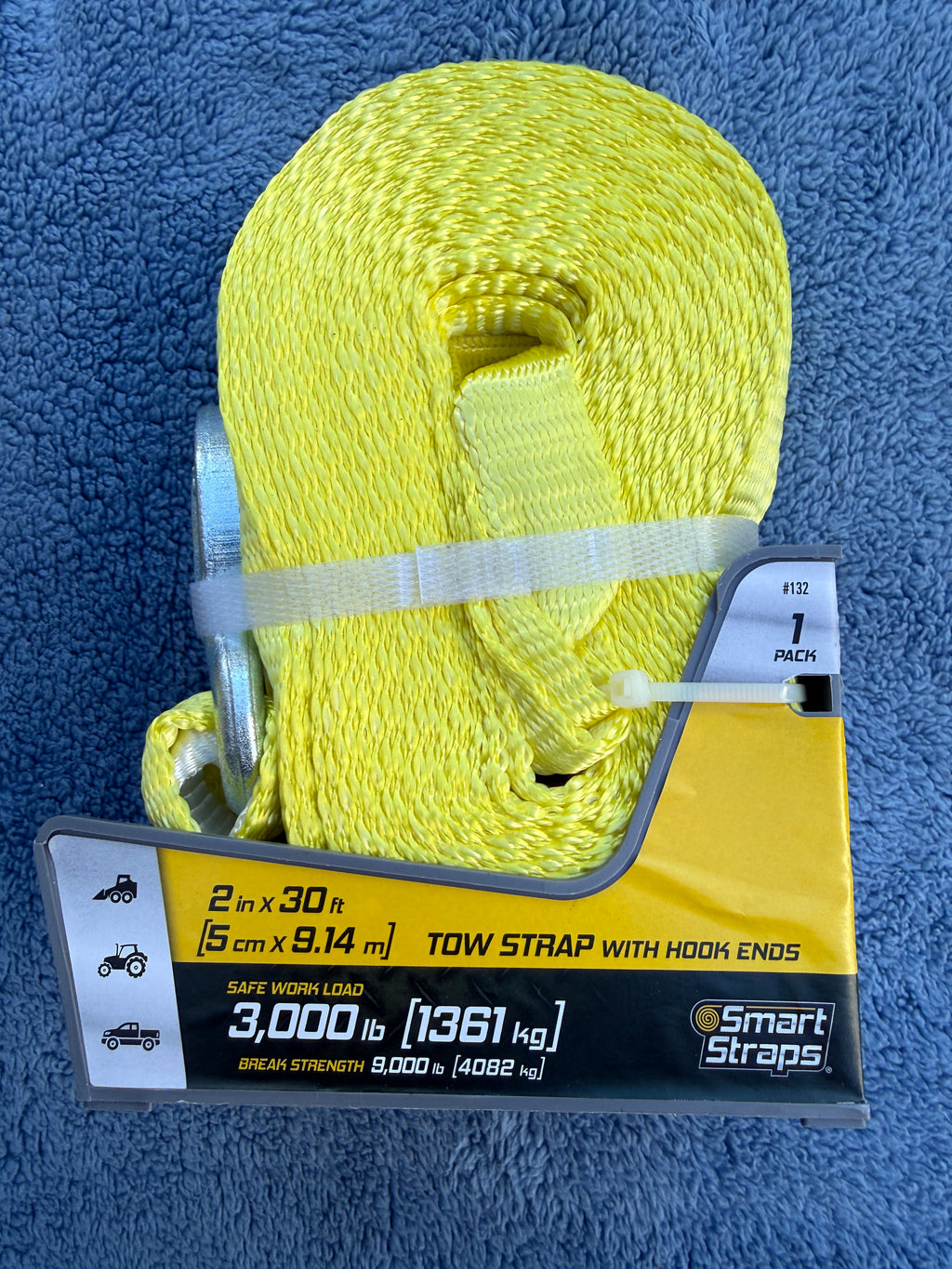 Side view of Smart Straps yellow tow strap with hook ends in packaging