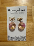 Hana_chica handcrafted resin earrings featuring natural flowers and gold bow accents on display card