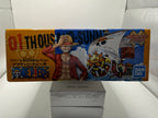 Side view of box featuring character Luffy and ship illustration