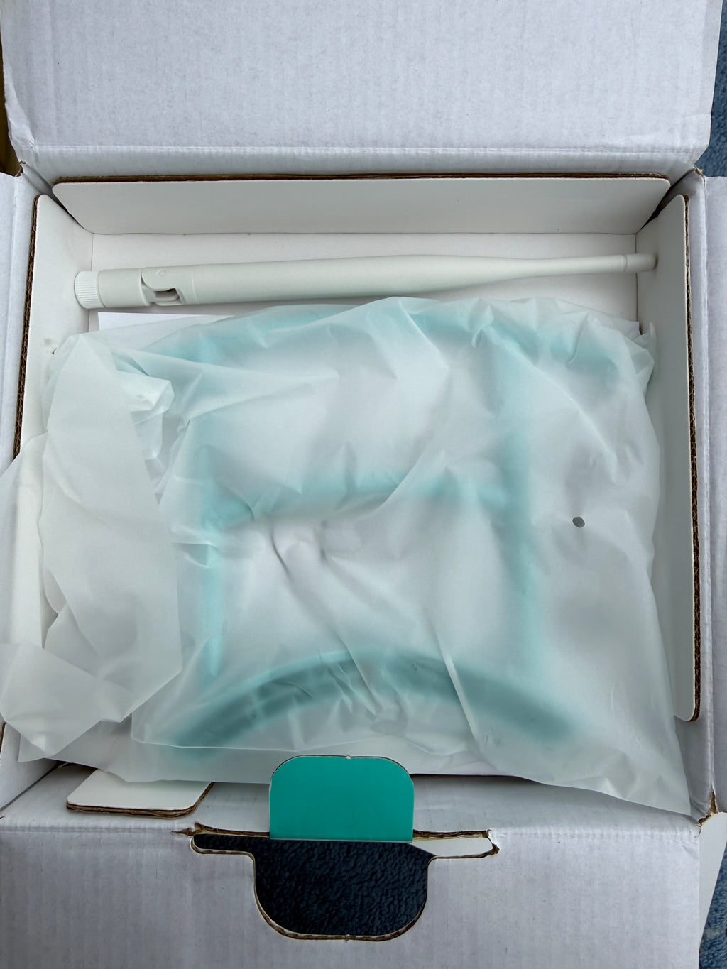 Opened Birdfy box with wrapped feeder and antenna
