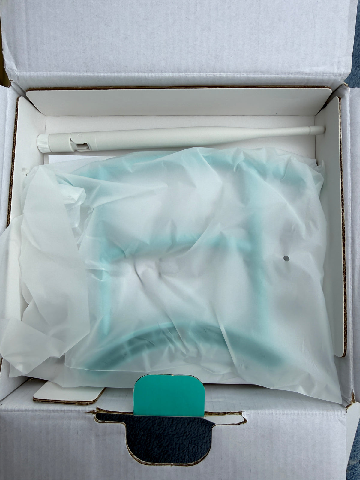 Opened Birdfy box with wrapped feeder and antenna