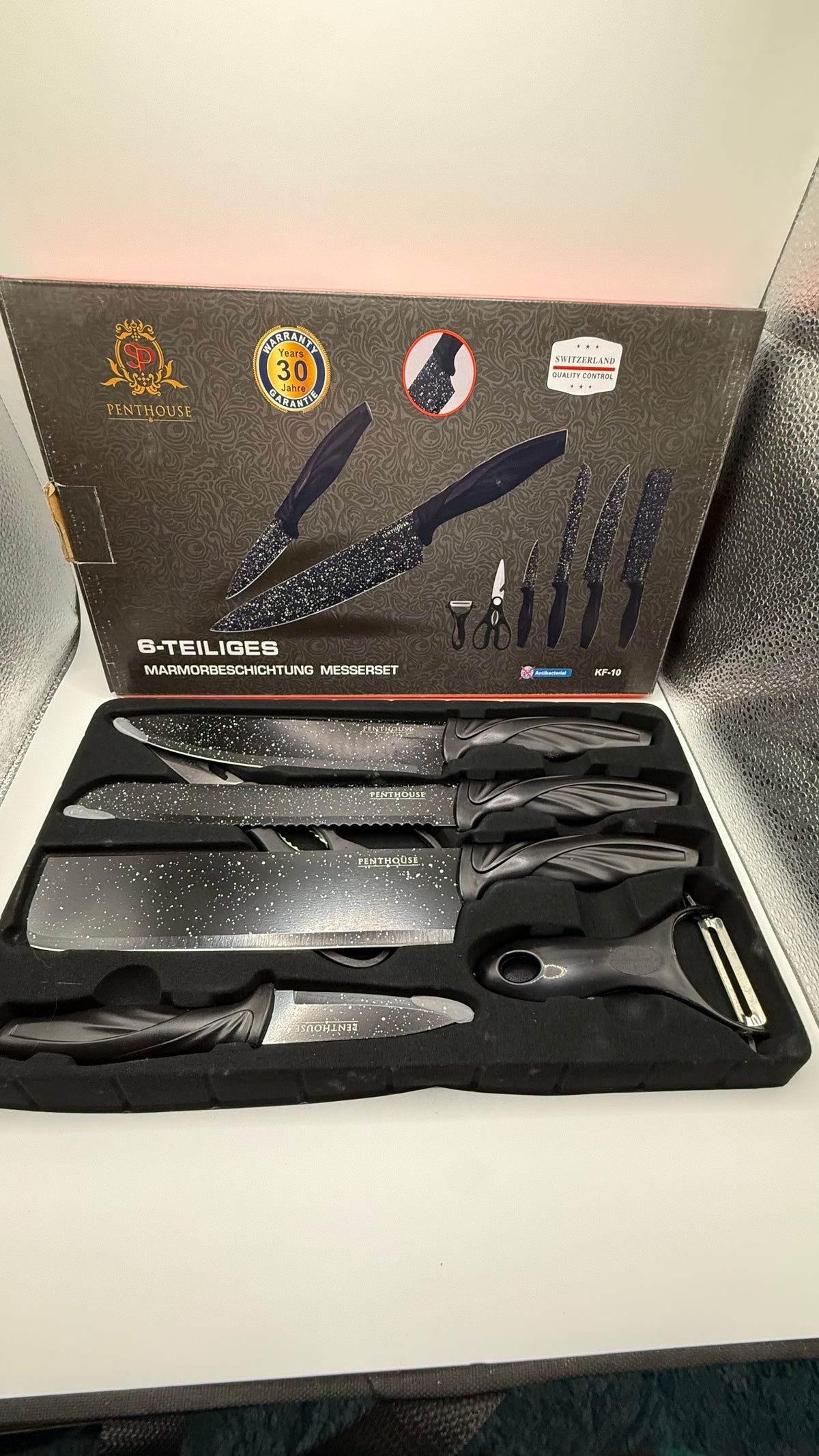 Close-up of Penthouse marble coated knives and peeler