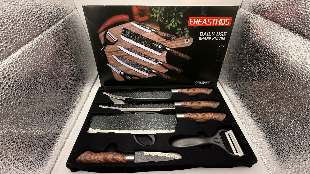 Opened box showing knives, peeler, and scissors in foam insert