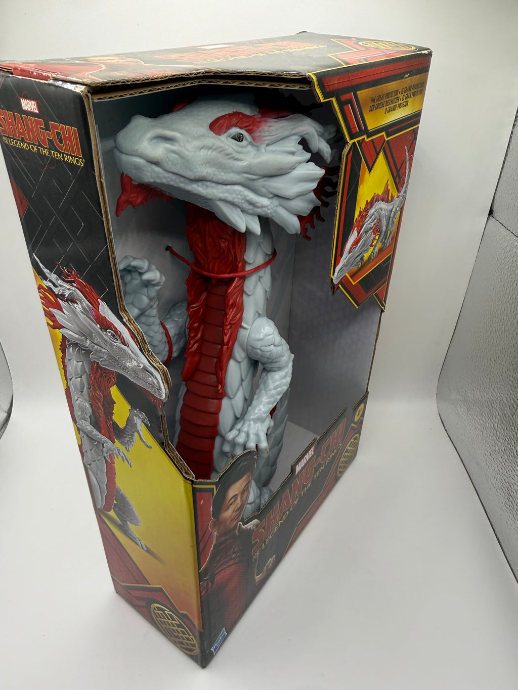Side view of Marvel Shang-Chi The Great Protector dragon figure in packaging