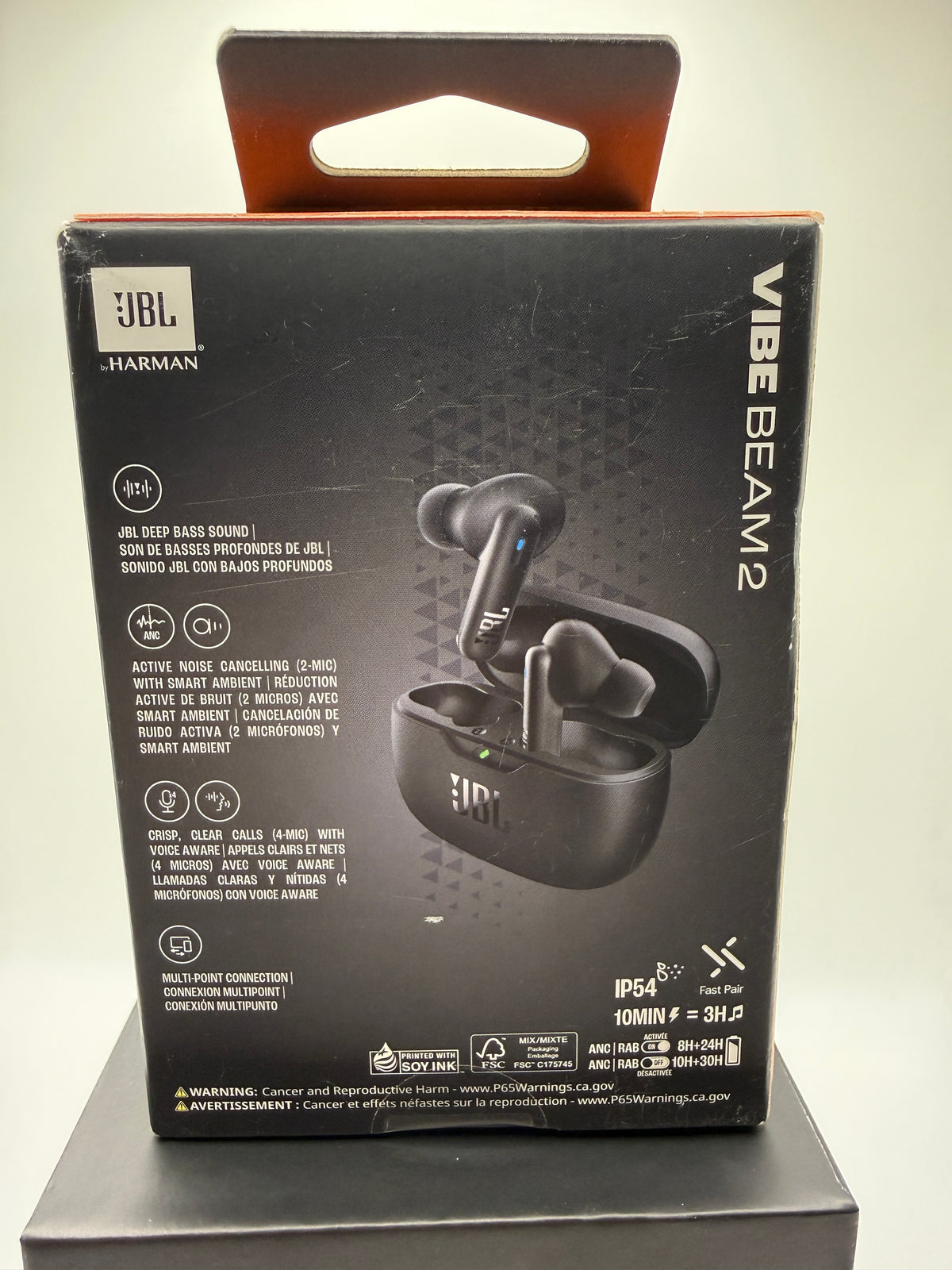 JBL Vibe Beam 2 earbuds in charging case with features list on box back