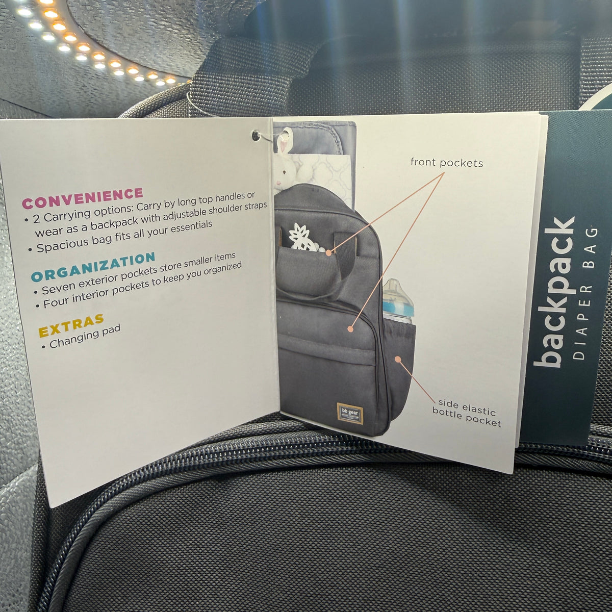 Open pamphlet showing pockets and features of bb gear backpack diaper bag