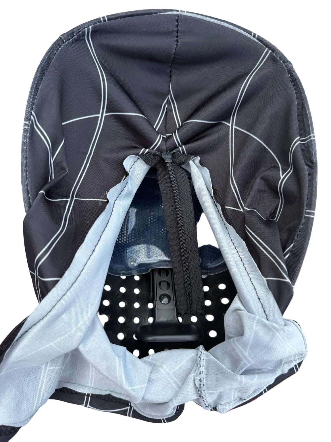 Interior of black Spider-Man mask showing rear zipper and plastic backing